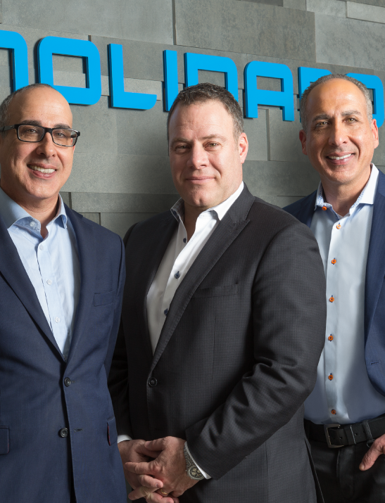 Three Molinaro Group developers smiling and posing